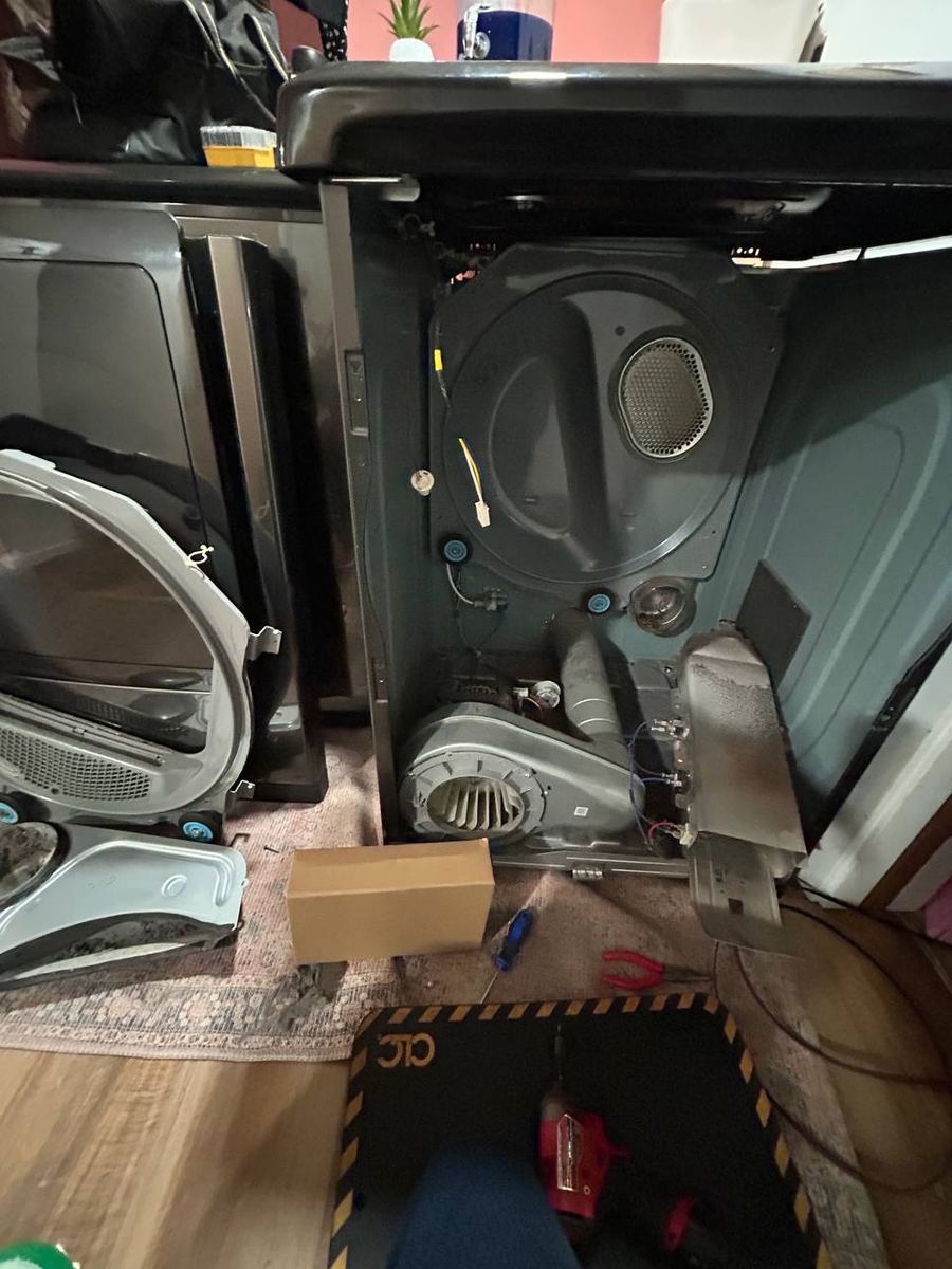 Dryer with the front panel removed to reach the blower and heater