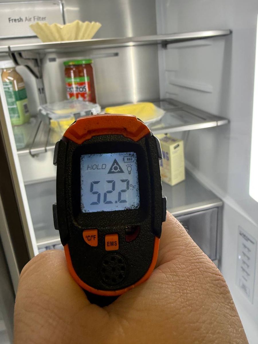Infrared thermometer reading a warm refrigerator compartment